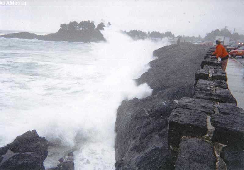 A giant wave crashes against the Highway 101 seawall in front of Depoe Bay
